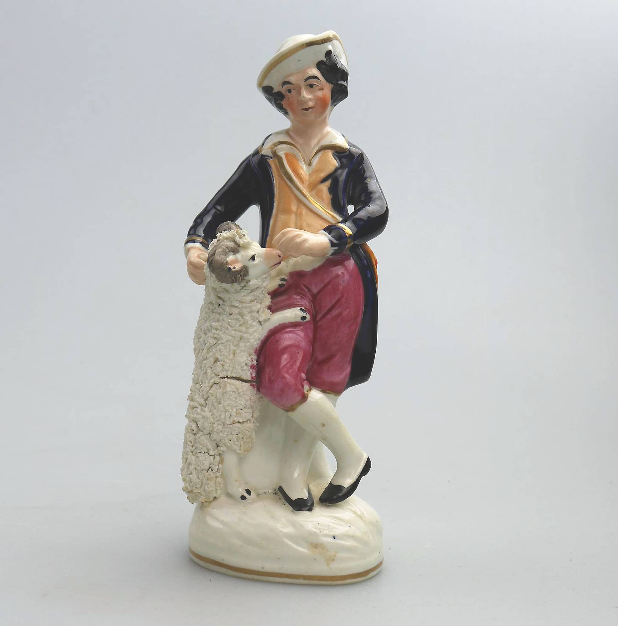 An antique Staffordshire pottery hand-painted Shepherd Figurine C.Mid 19thC