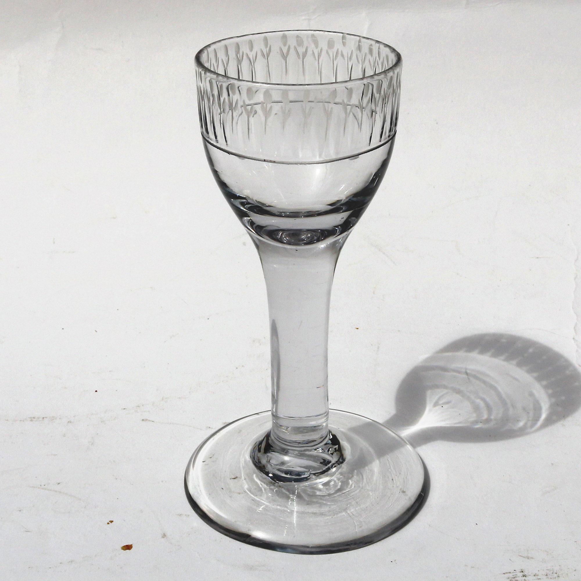 A very unusual antique Georgian stemware glass with engraved tulip border C.18thC