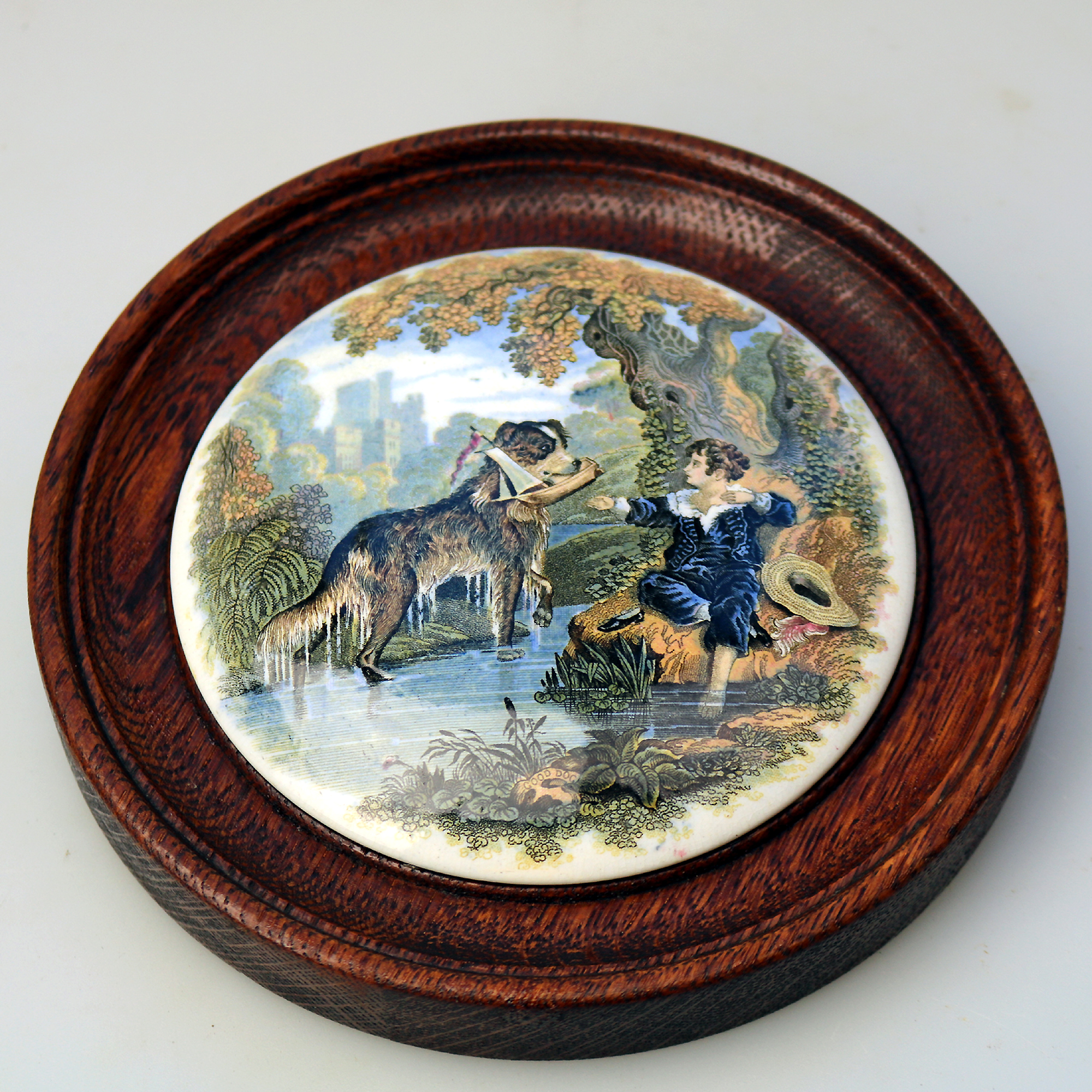 An antique framed English Prattware pottery Pot Lid Good Dog C.19thC