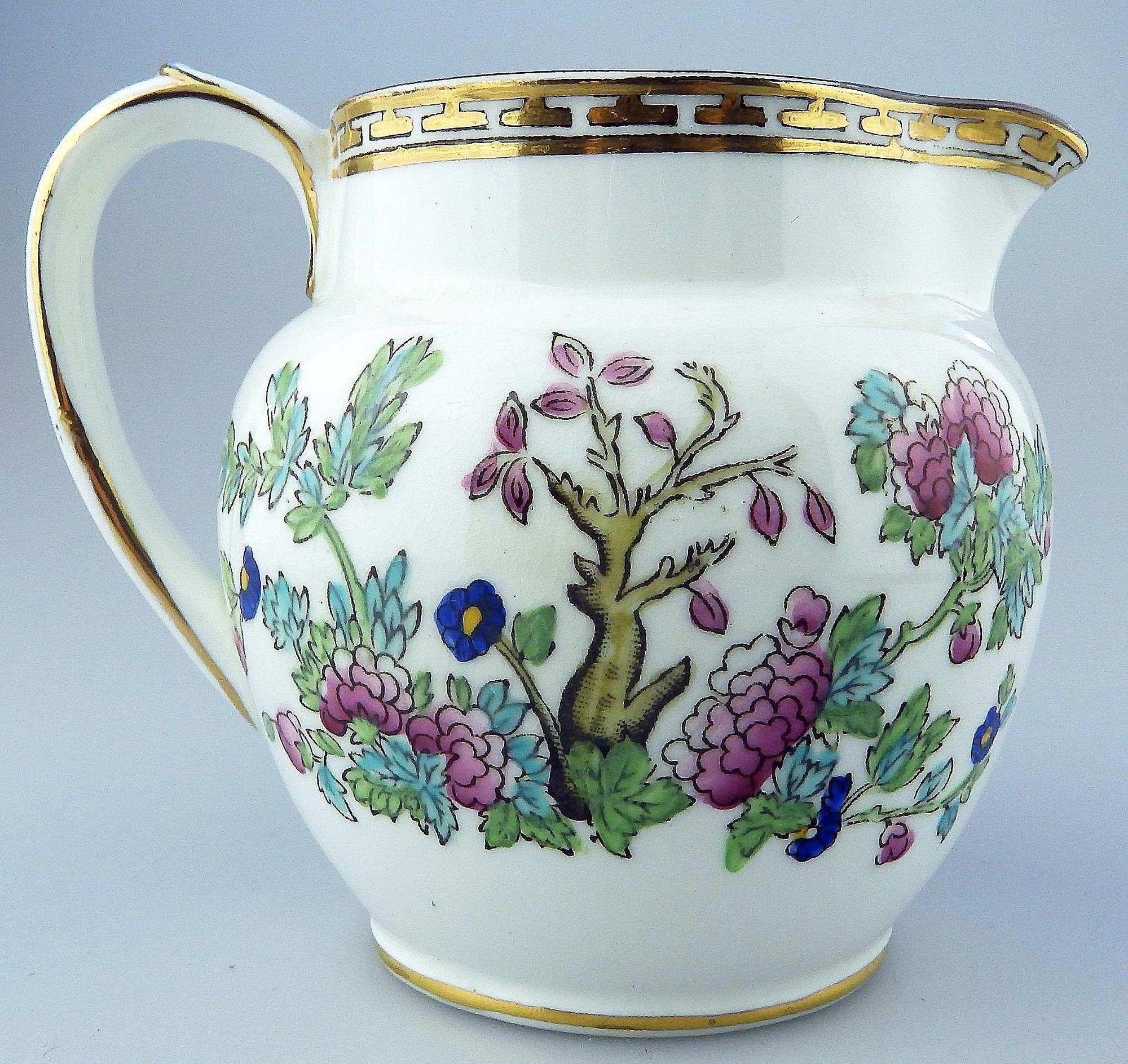 An antique Harrods Victorian pottery hand coloured Indian Tree Jug C.1891+