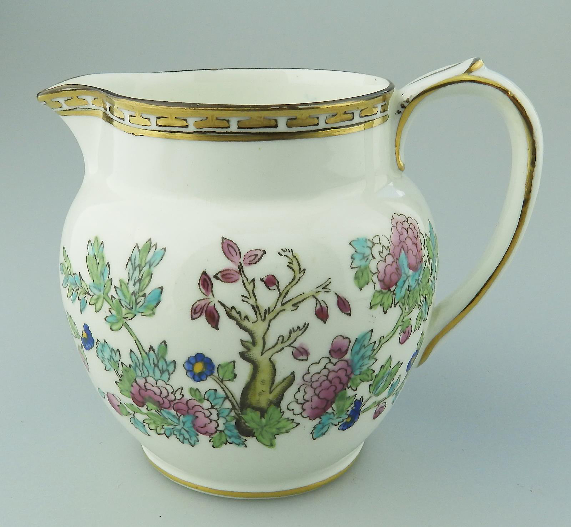 An antique Harrods Victorian pottery hand coloured Indian Tree Jug C.1891+