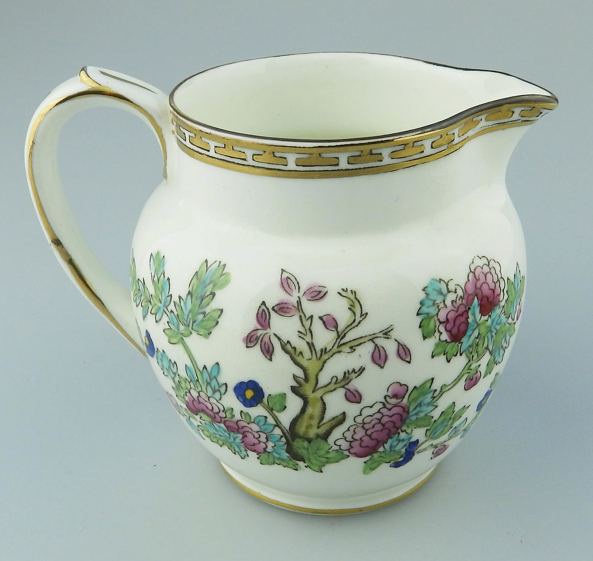 An antique Harrods Victorian pottery hand coloured Indian Tree Jug C.1891+