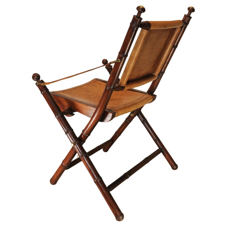 A Folding Safari Chair With Stitched Tan Leather Straps & Seat Faux Bamboo Legs