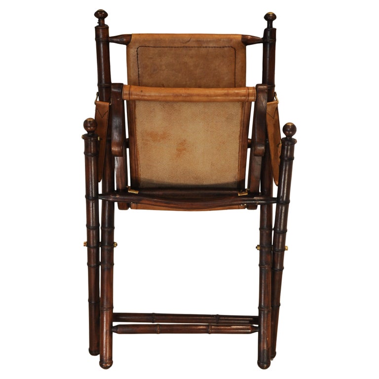 A Folding Safari Chair With Stitched Tan Leather Straps & Seat Faux Bamboo Legs