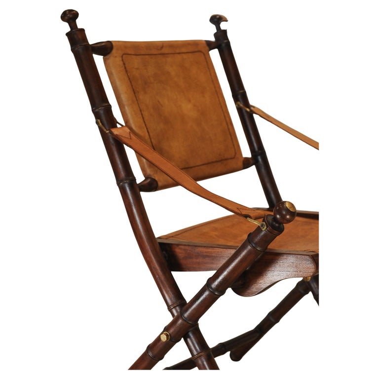 A Folding Safari Chair With Stitched Tan Leather Straps & Seat Faux Bamboo Legs