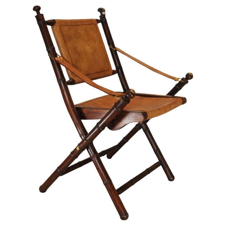 A Folding Safari Chair With Stitched Tan Leather Straps & Seat Faux Bamboo Legs