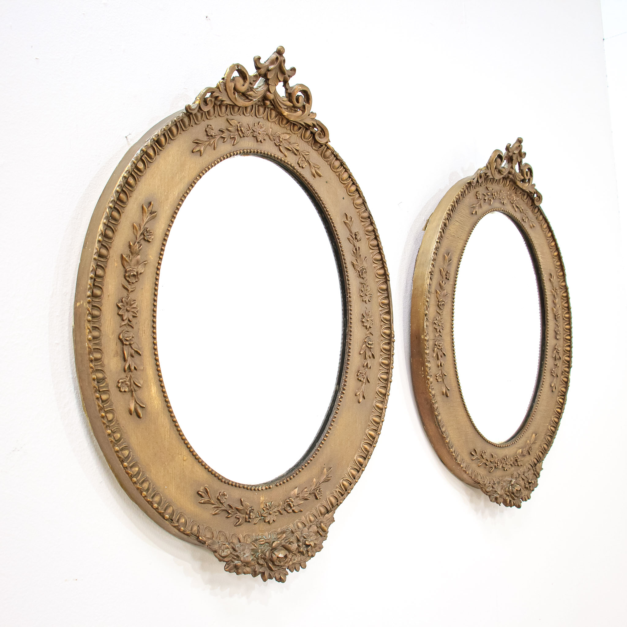 Pair of Oval Mirrors in Bronzed Ornate Wood Frames