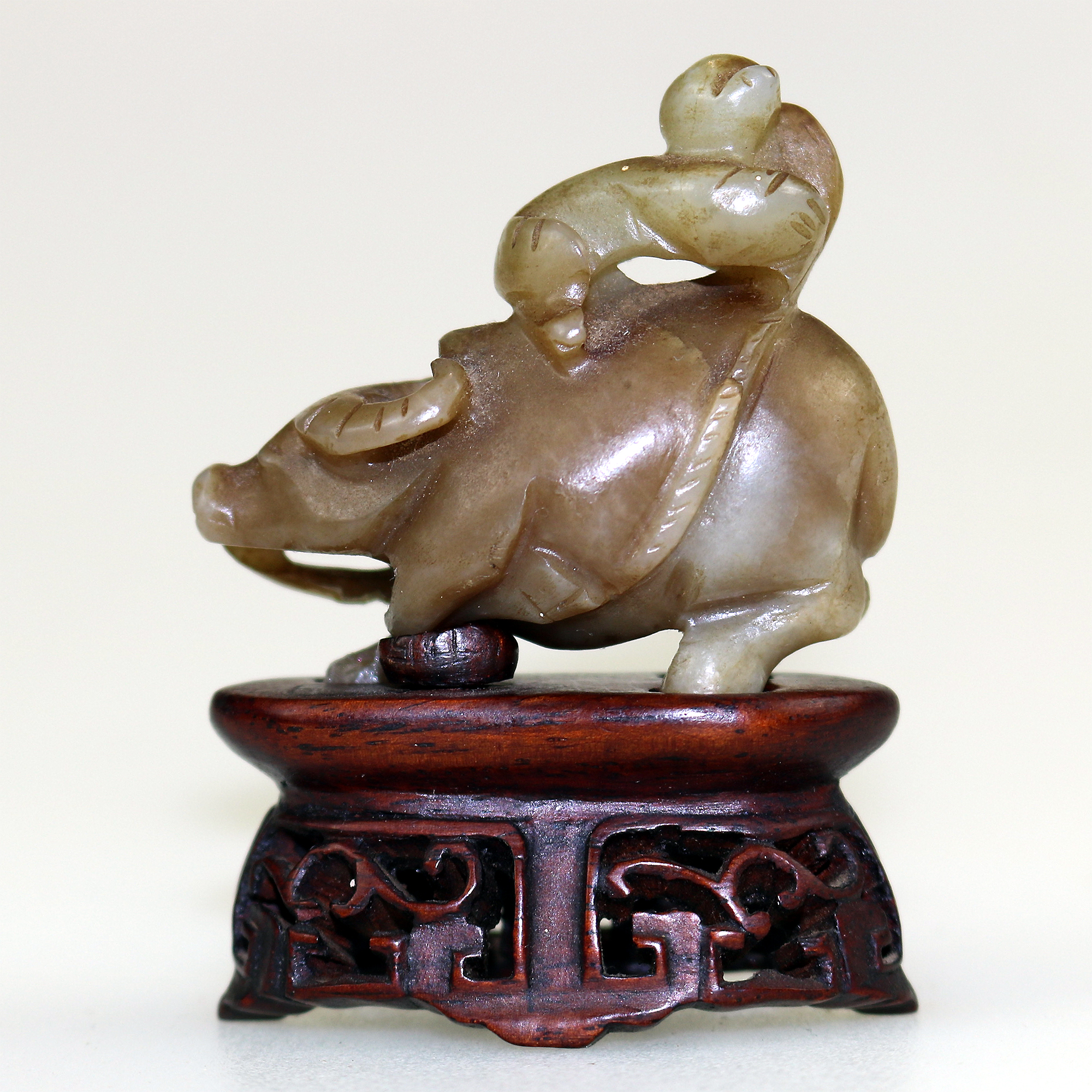 An antique miniature hand carved hardstone nephrite Figure on stand C.19th/20thC