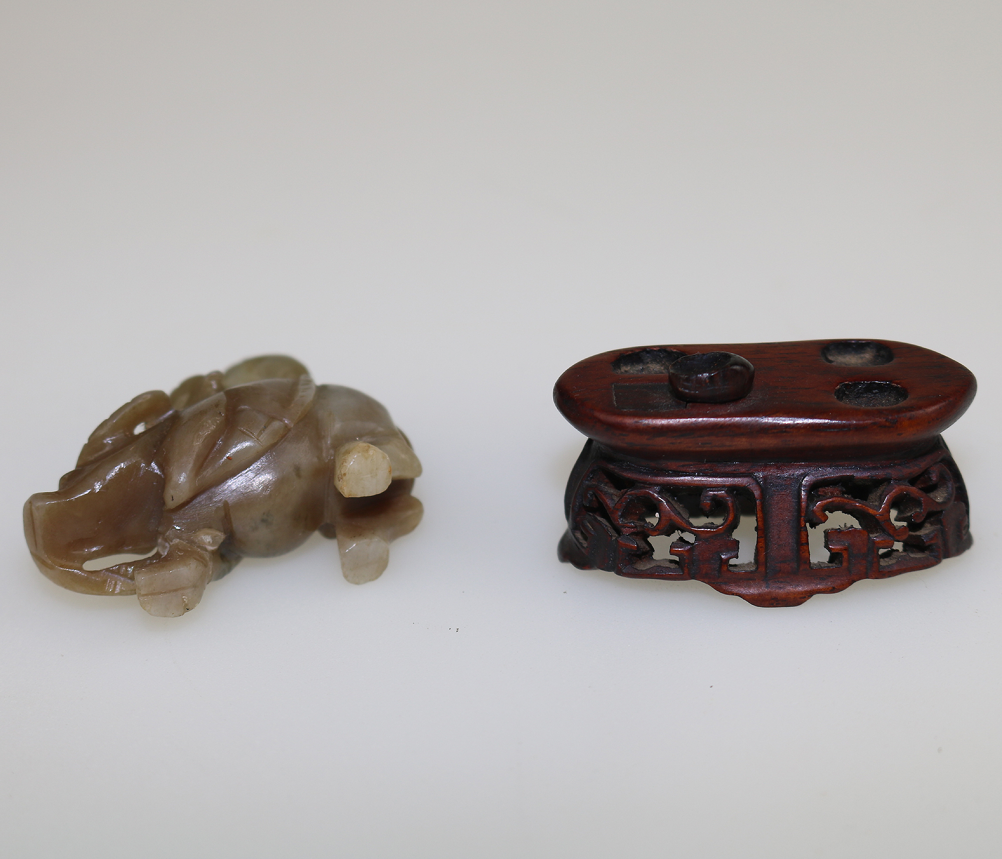 An antique miniature hand carved hardstone nephrite Figure on stand C.19th/20thC