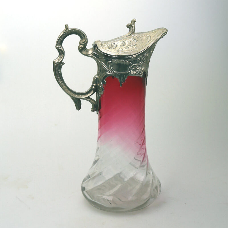 A substantial antique Art Nouveau cranberry glass wrythen Claret Jug C. pre 1900
