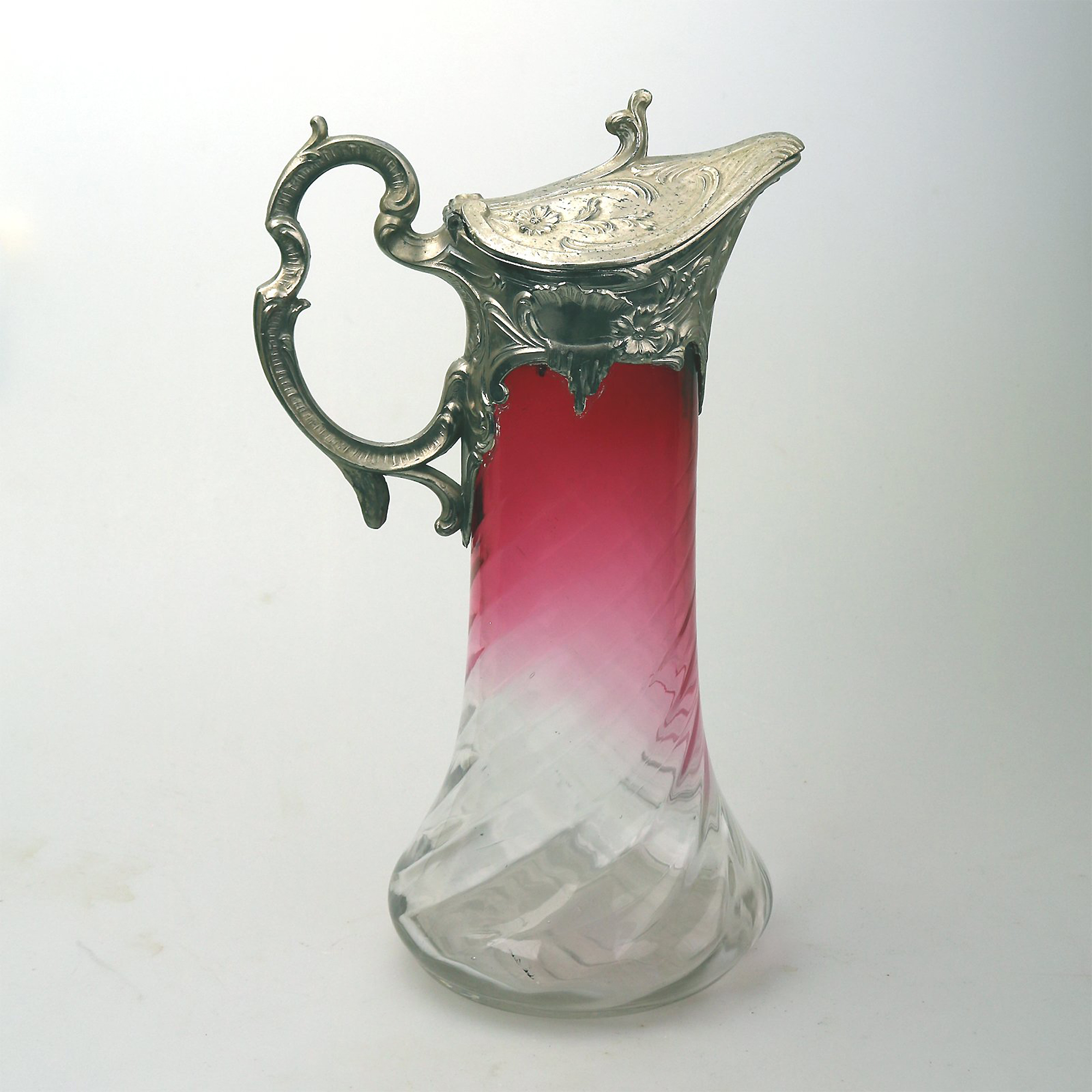 A substantial antique Art Nouveau cranberry glass wrythen Claret Jug C. pre 1900