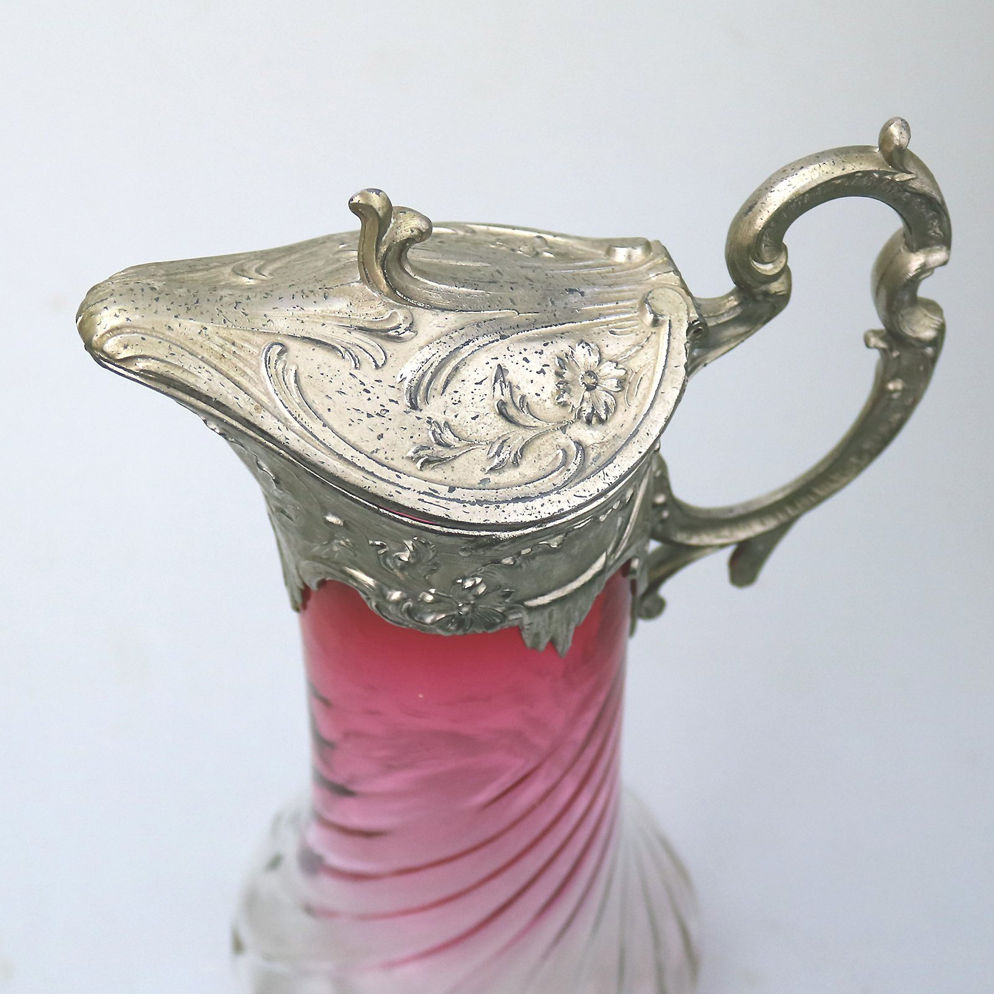 A substantial antique Art Nouveau cranberry glass wrythen Claret Jug C. pre 1900