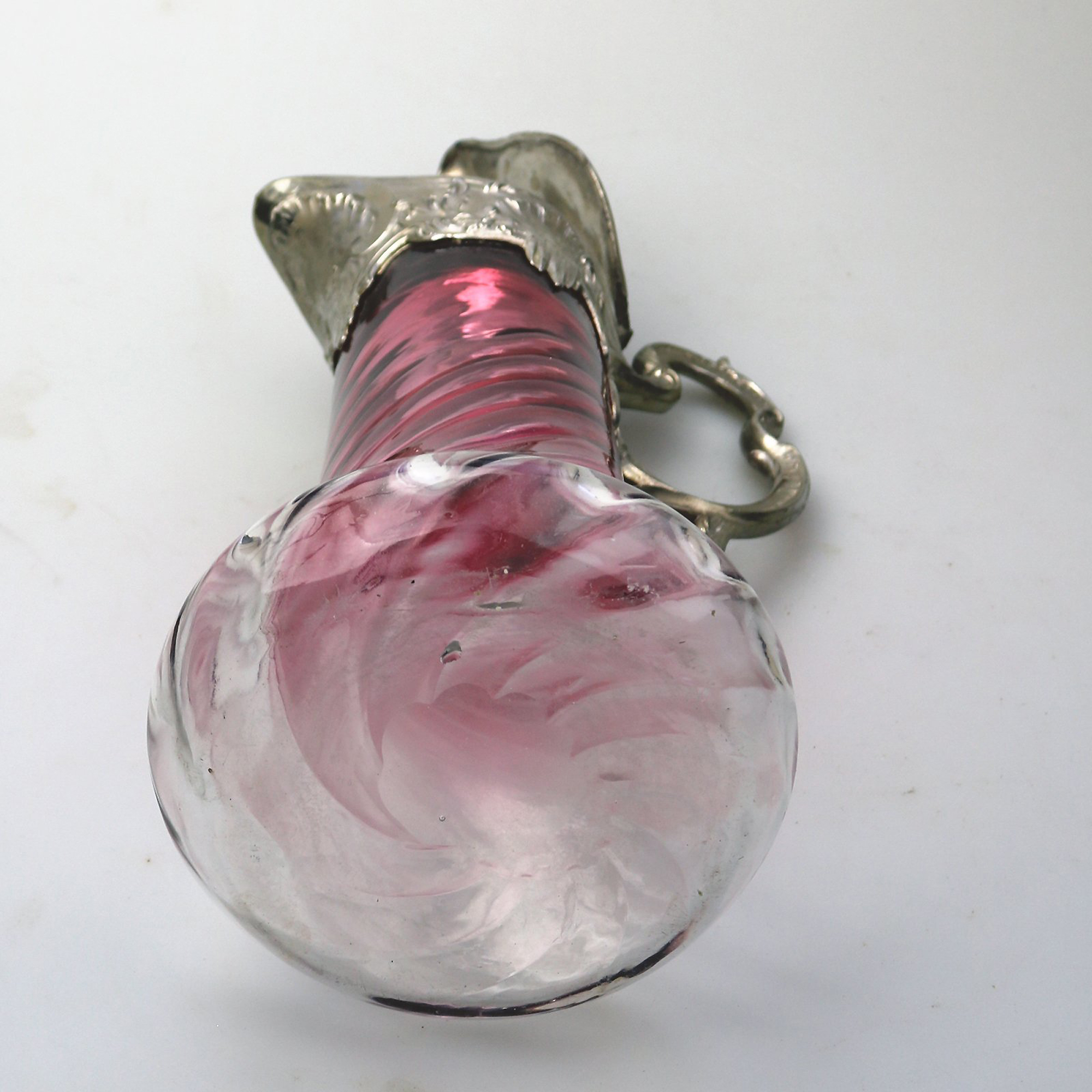 A substantial antique Art Nouveau cranberry glass wrythen Claret Jug C. pre 1900