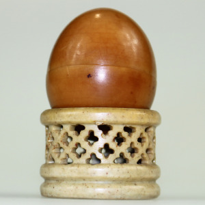 An unusual antique oriental threaded carved nut box on hardstone stand C.1900