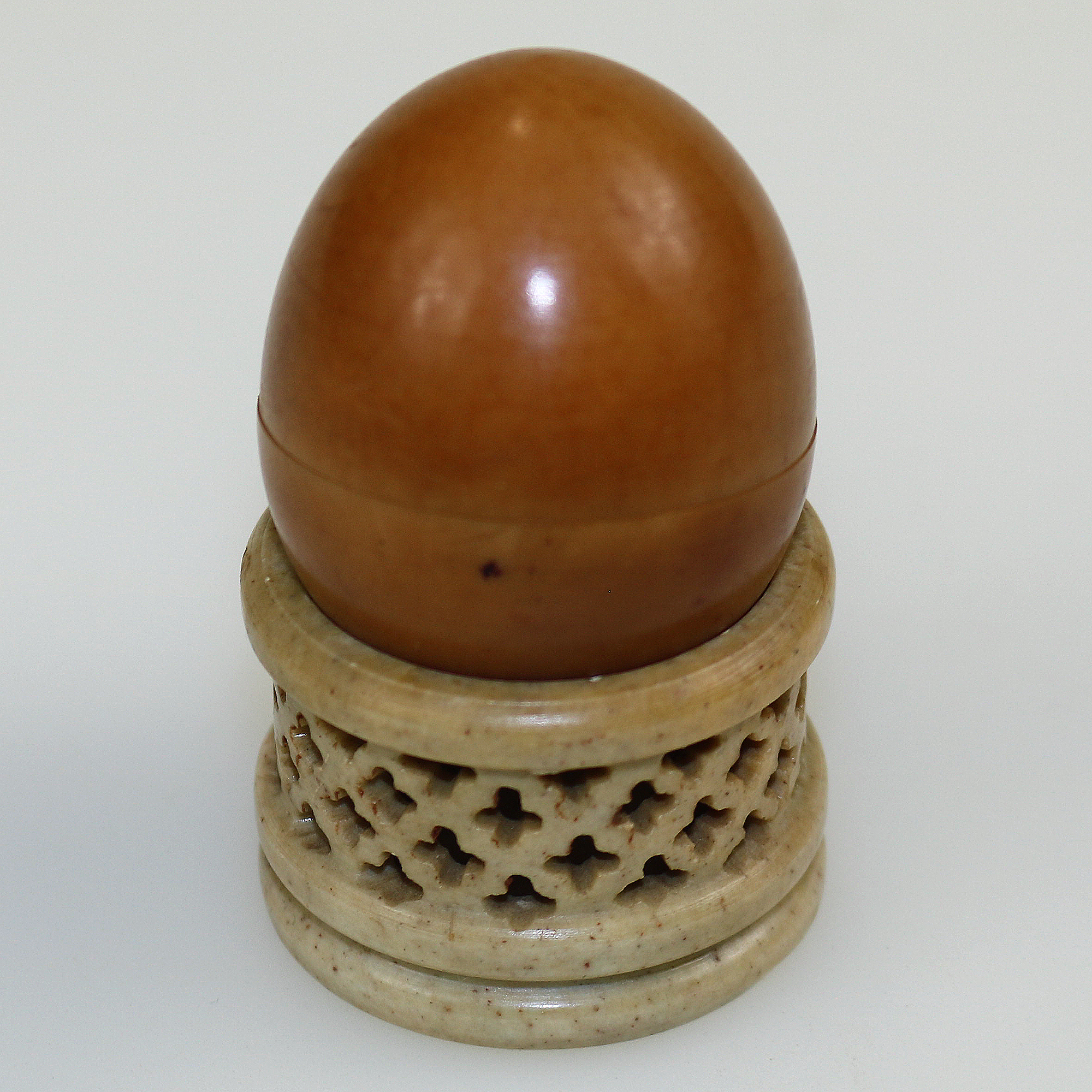 An unusual antique oriental threaded carved nut box on hardstone stand C.1900
