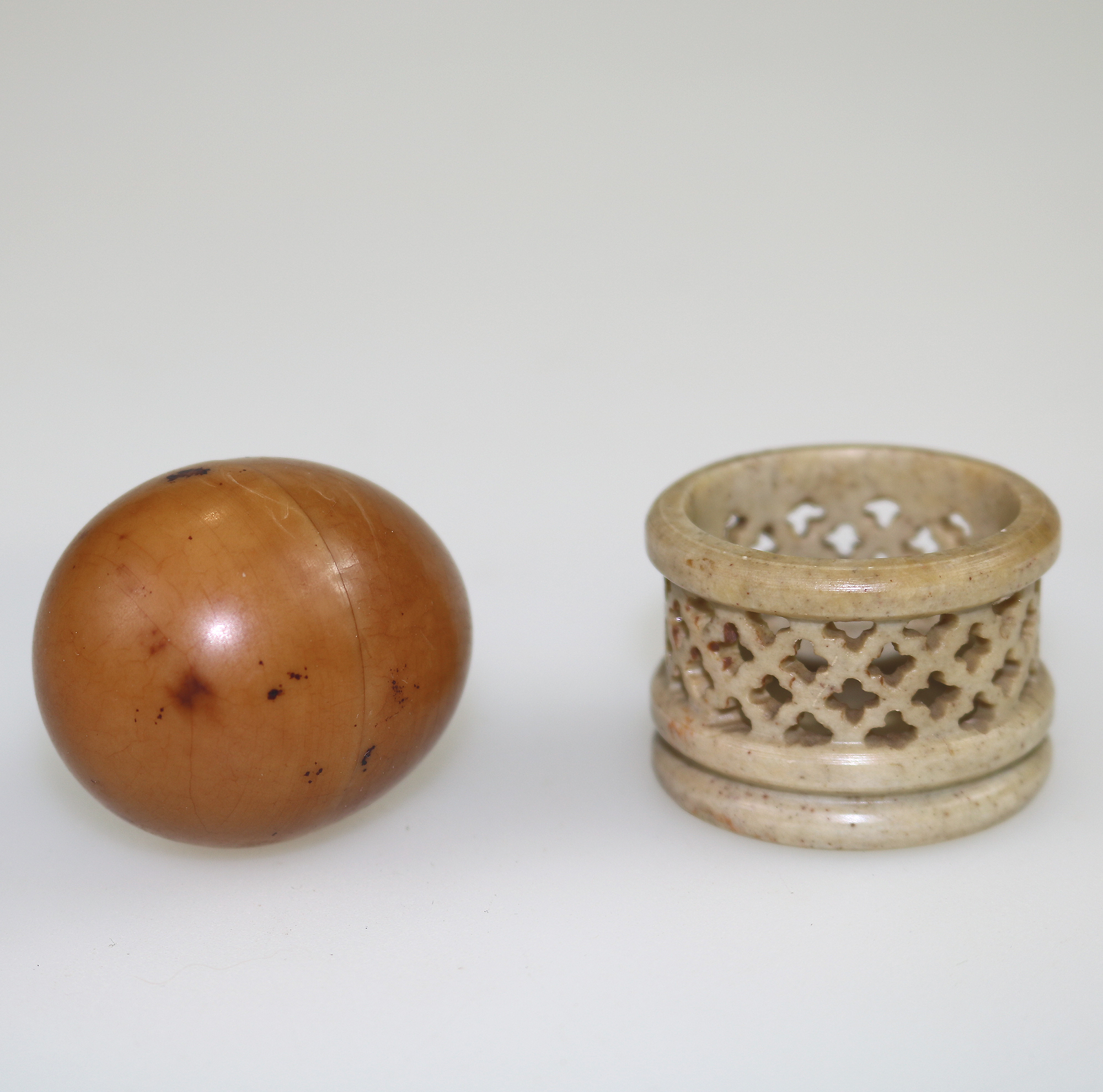An unusual antique oriental threaded carved nut box on hardstone stand C.1900