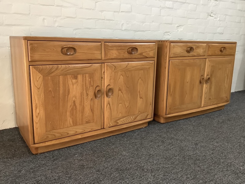 Pair Of Ercol Windsor Sideboard Cabinets In Light Finish.