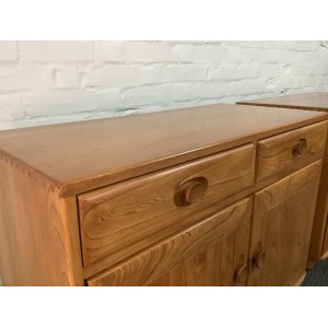 Pair Of Ercol Windsor Sideboard Cabinets In Light Finish.