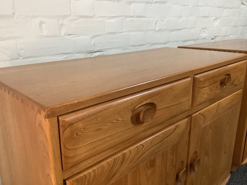 Pair Of Ercol Windsor Sideboard Cabinets In Light Finish.