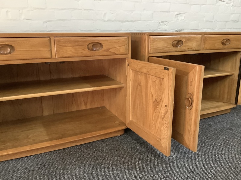 Pair Of Ercol Windsor Sideboard Cabinets In Light Finish.