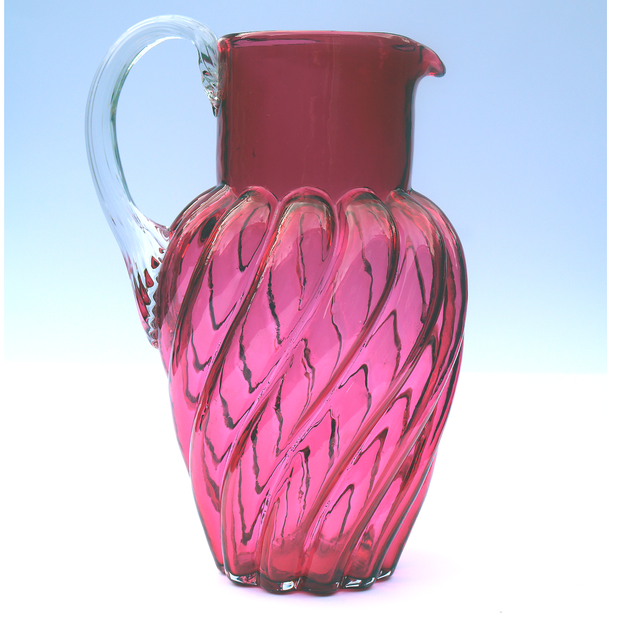 An extraordinary and large antique wrythen pattern cranberry glass Jug C.1900