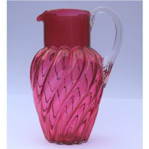 An extraordinary and large antique wrythen pattern cranberry glass Jug C.1900