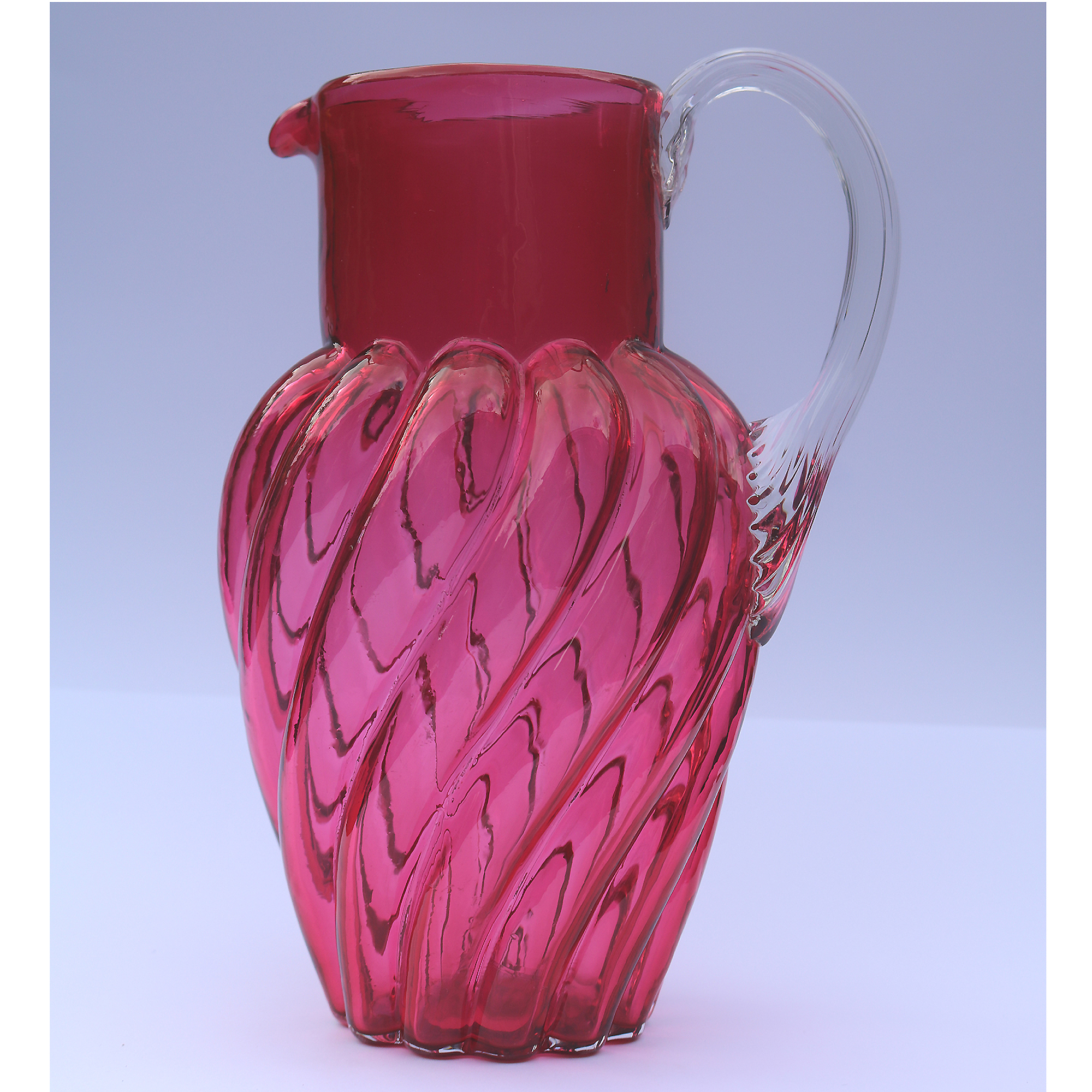 An extraordinary and large antique wrythen pattern cranberry glass Jug C.1900