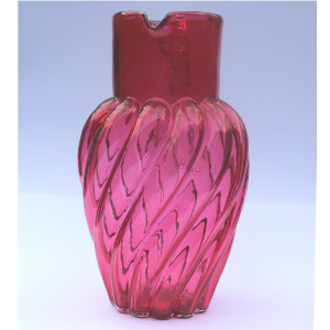 An extraordinary and large antique wrythen pattern cranberry glass Jug C.1900