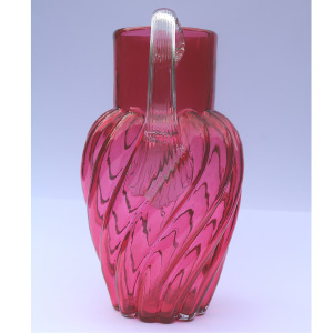 An extraordinary and large antique wrythen pattern cranberry glass Jug C.1900