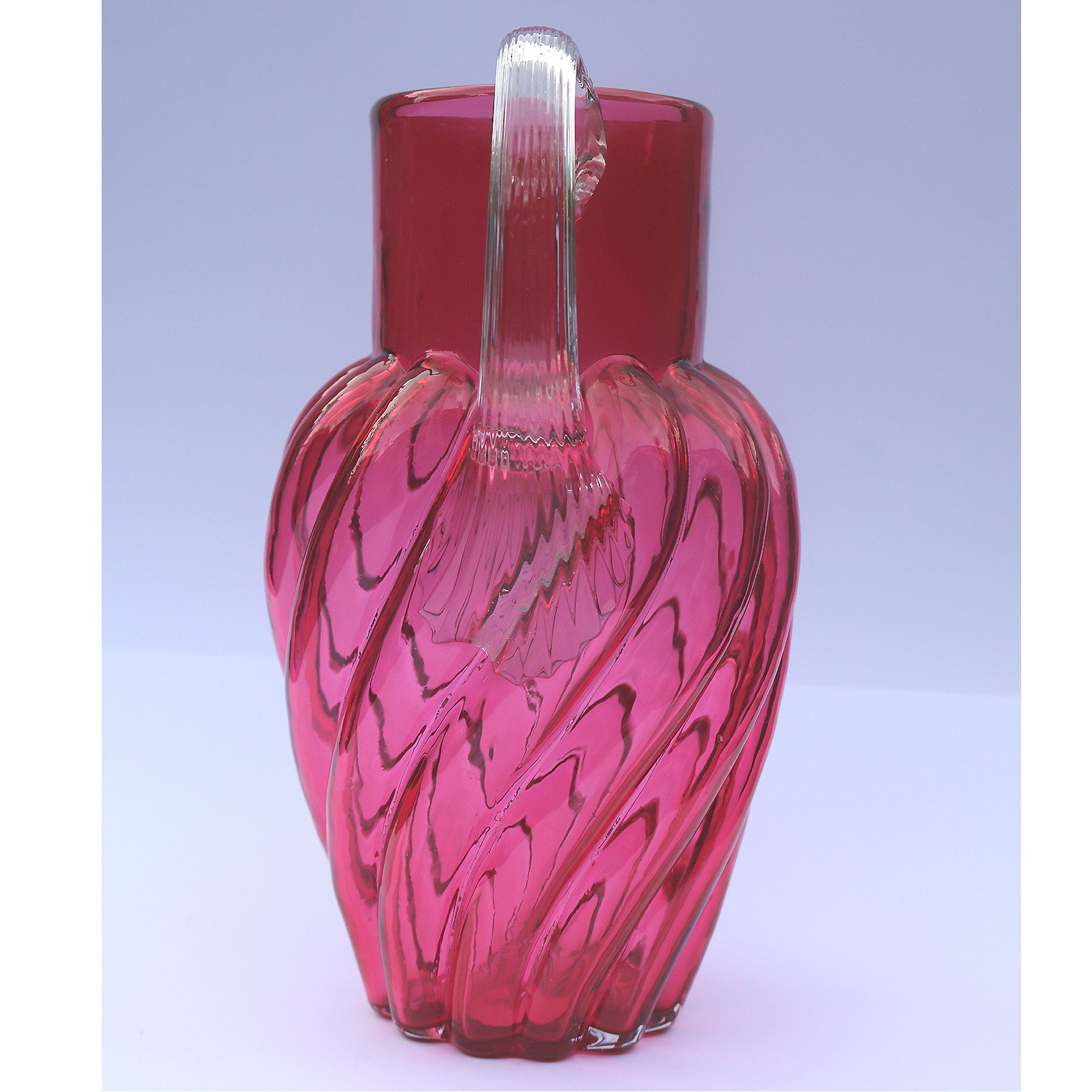 An extraordinary and large antique wrythen pattern cranberry glass Jug C.1900