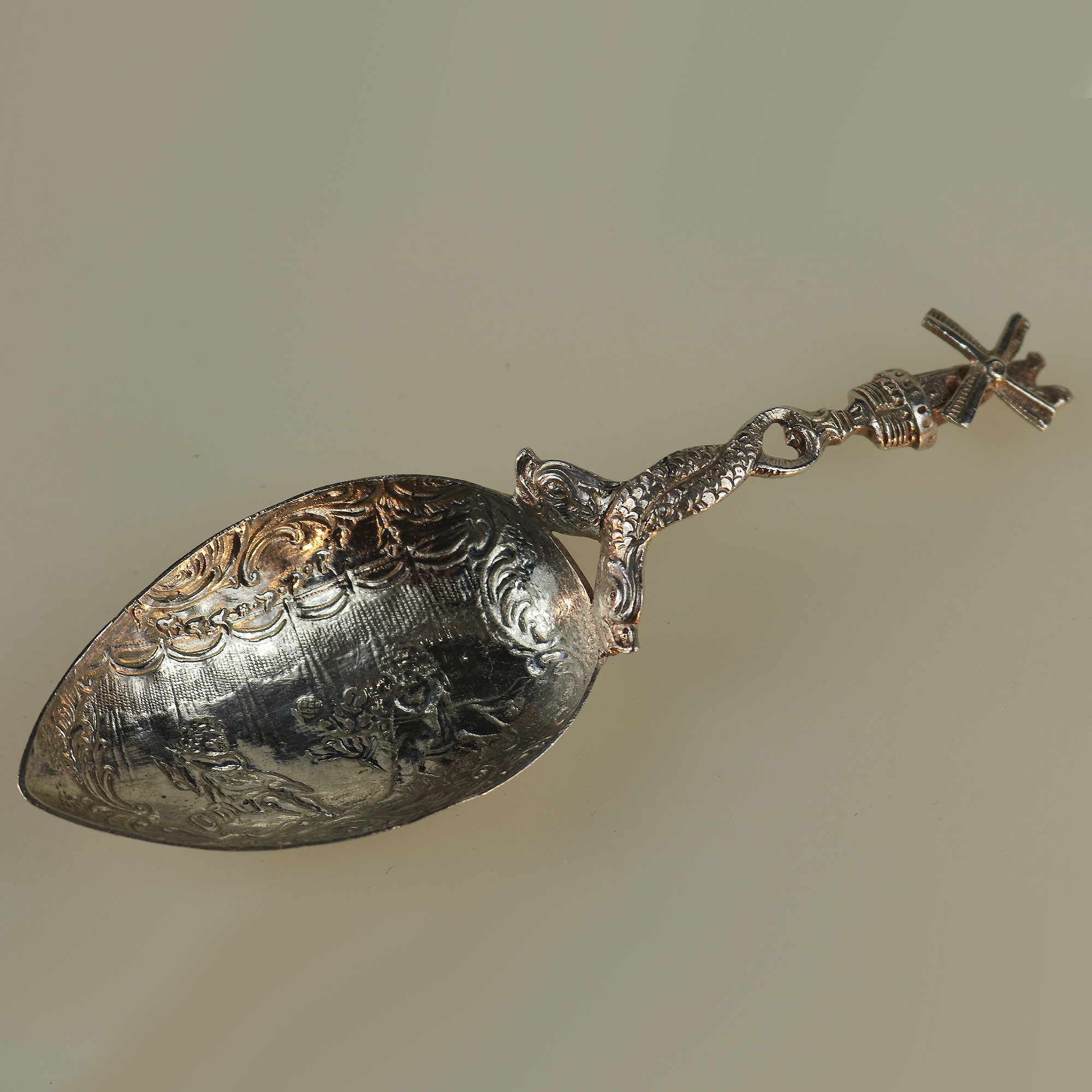 A 925 solid silver Caddy Spoon with twin dolphin and windmill stem C.early 20thC