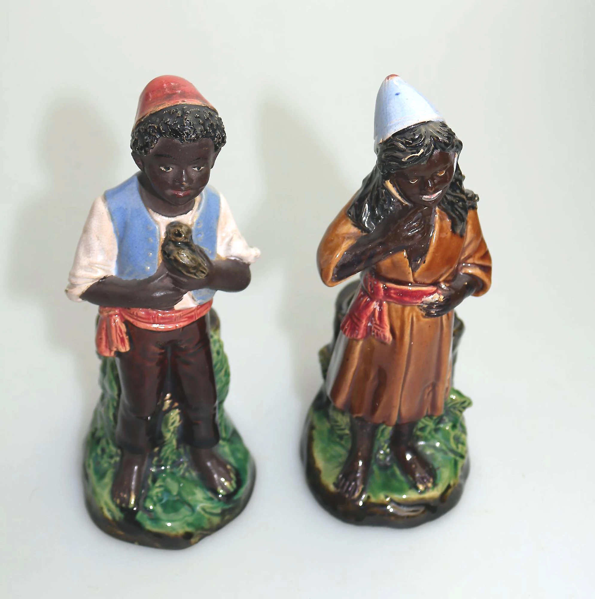 A pair antique majolica Bernhard Bloch pottery Children Figural Strikers C.19thC