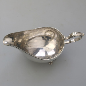 An antique Georgian Irish solid silver Sauceboat Gravy Jug by Mathew West C.1789
