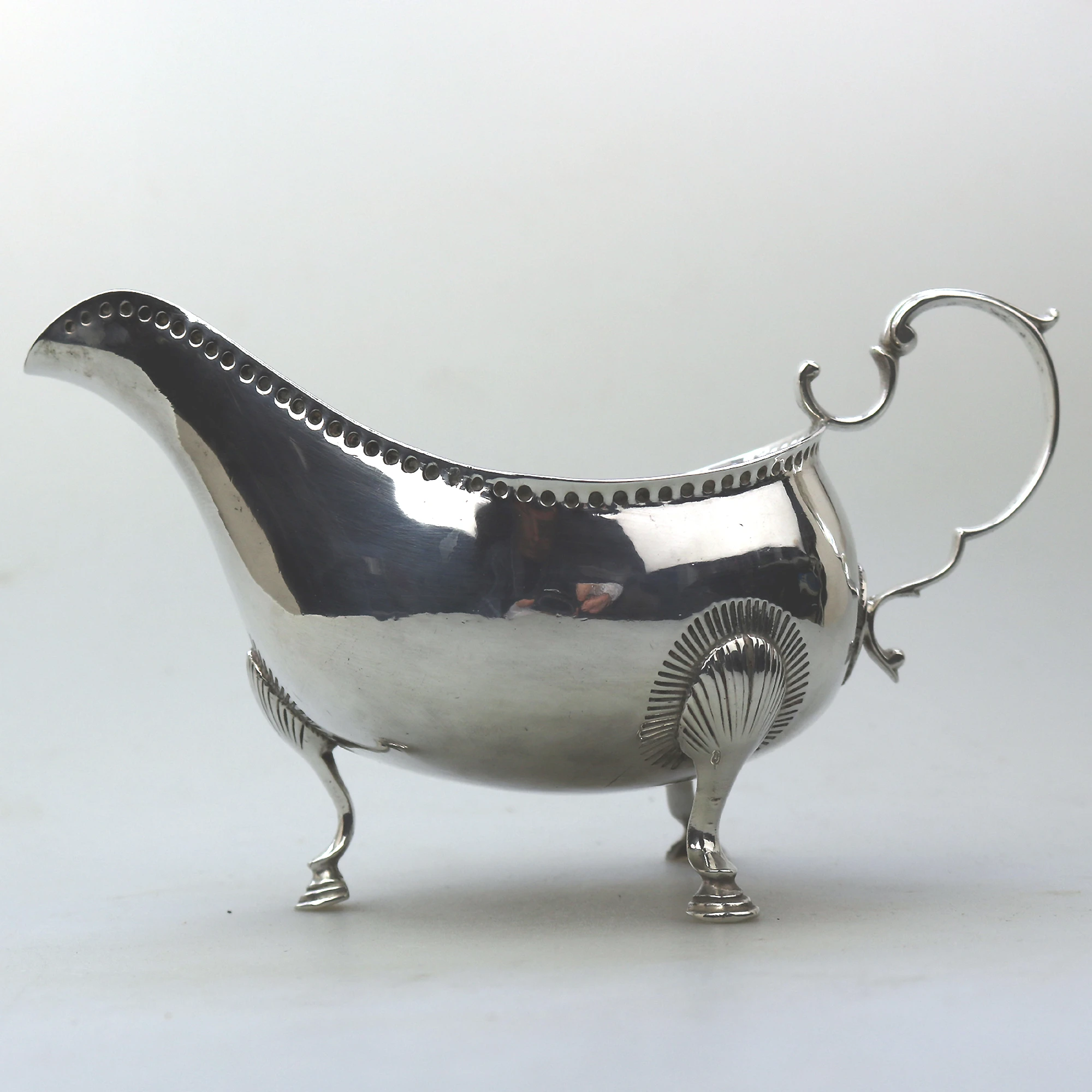 An antique Georgian Irish solid silver Sauceboat Gravy Jug by Mathew West C.1789