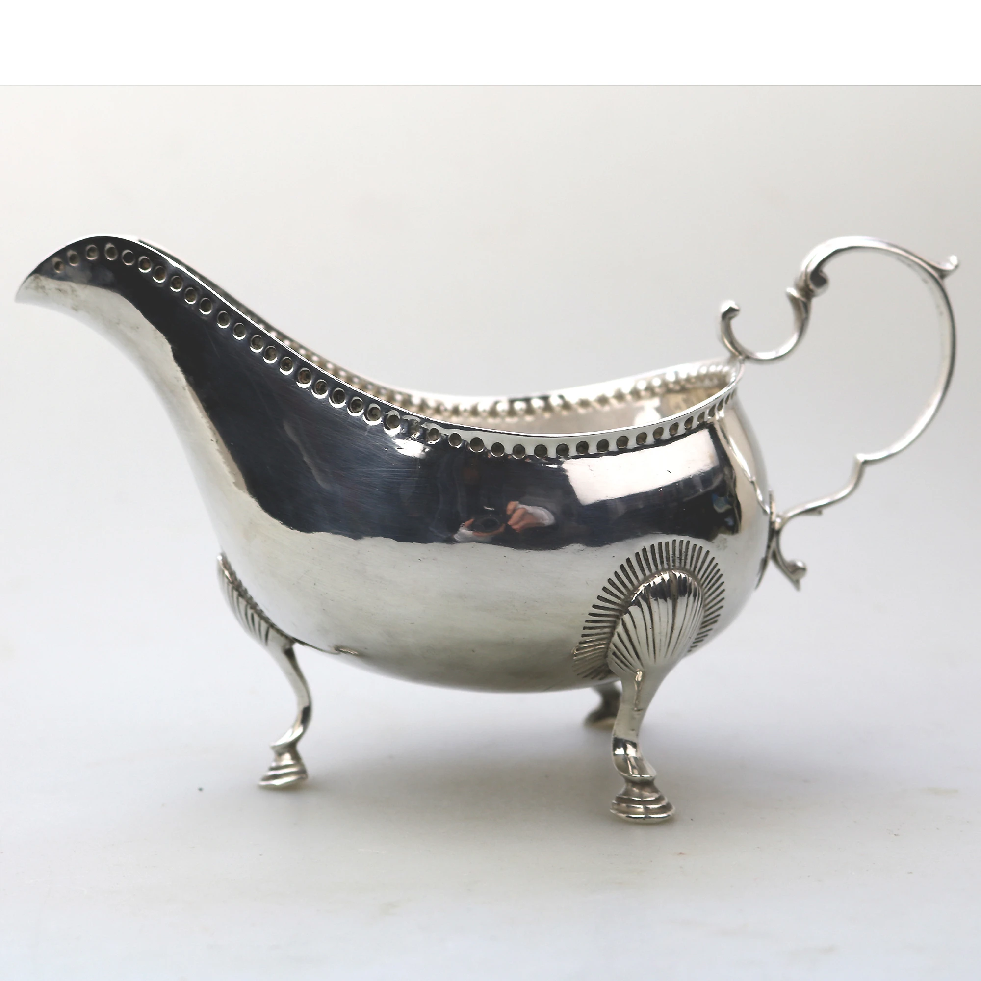 An antique Georgian Irish solid silver Sauceboat Gravy Jug by Mathew West C.1789