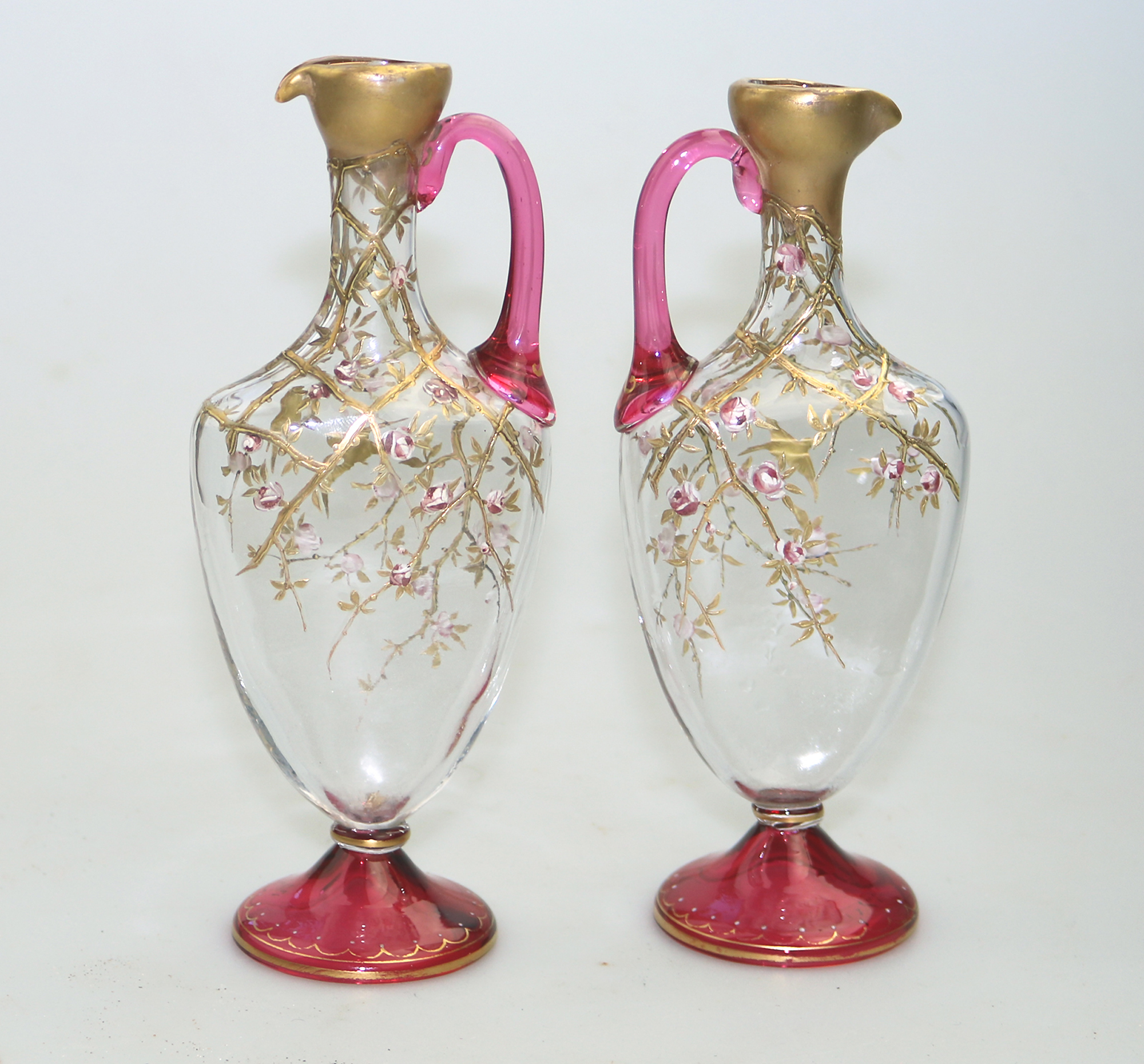 A superb pair antique cranberry glass & gilt overlaid Moser type Ewers C.19thC