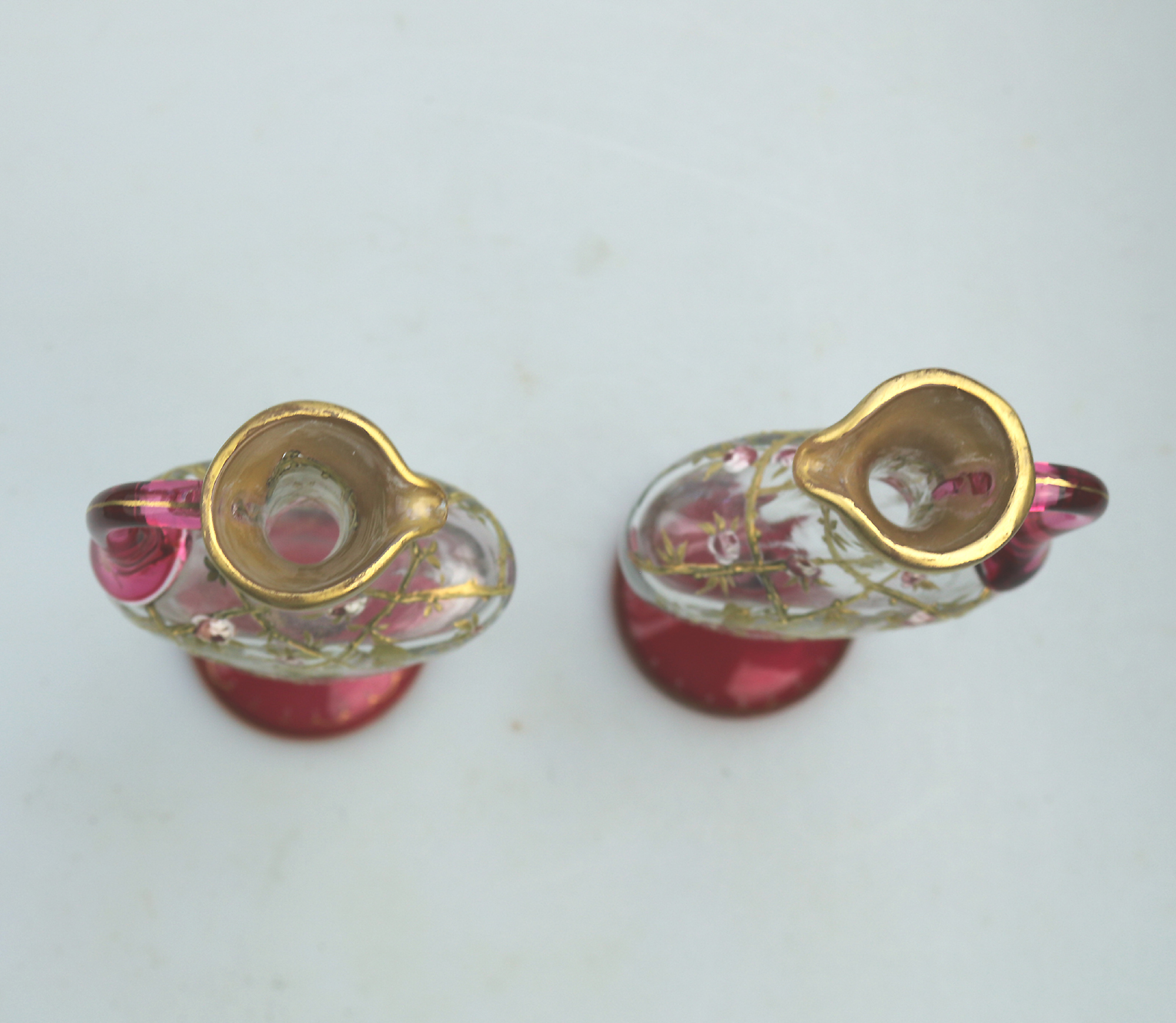A superb pair antique cranberry glass & gilt overlaid Moser type Ewers C.19thC