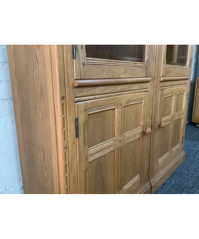 Pair Of Ercol Mural Glazed Cabinets In Light Finish.