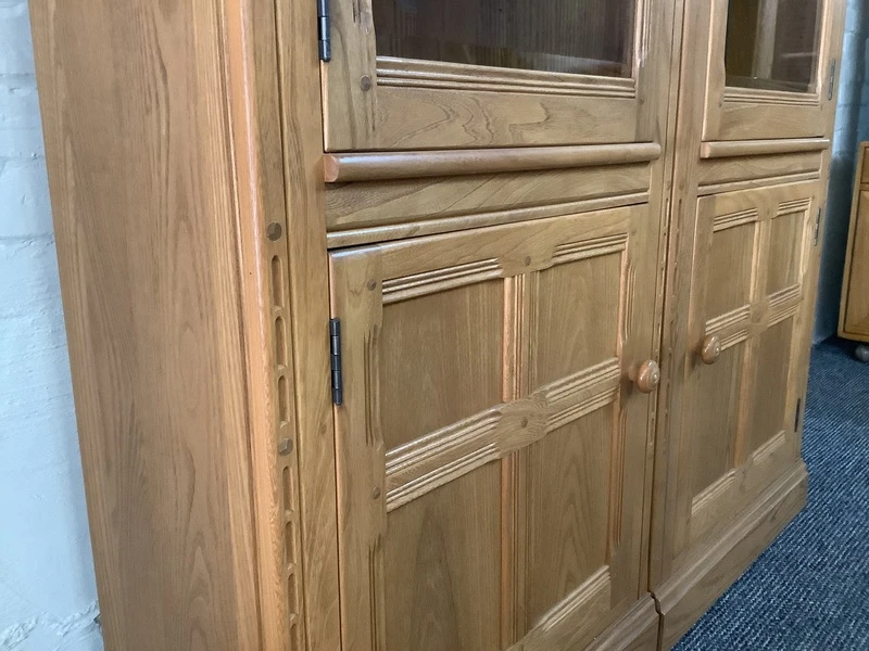 Pair Of Ercol Mural Glazed Cabinets In Light Finish.