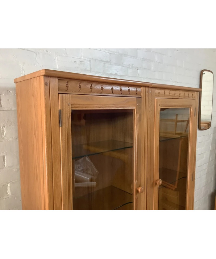 Pair Of Ercol Mural Glazed Cabinets In Light Finish.