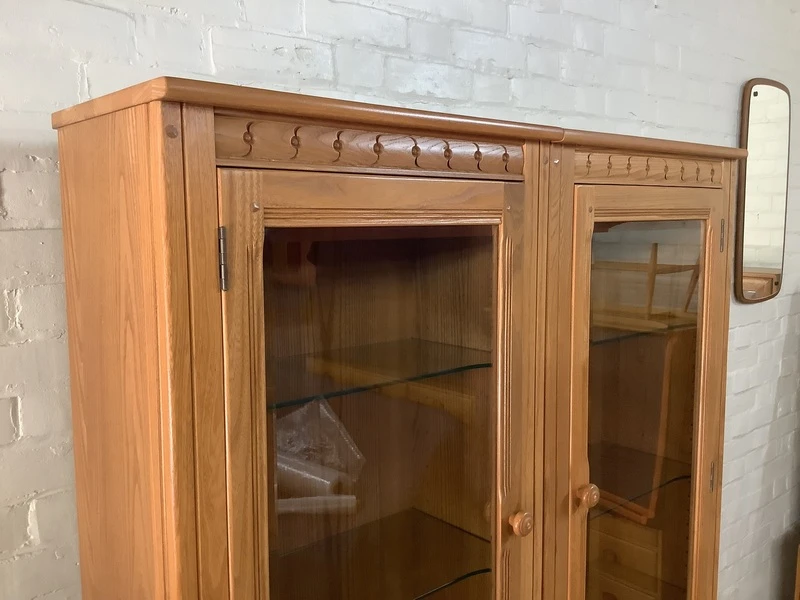 Pair Of Ercol Mural Glazed Cabinets In Light Finish.