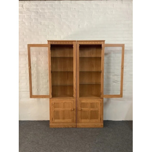 Pair Of Ercol Mural Glazed Cabinets In Light Finish.