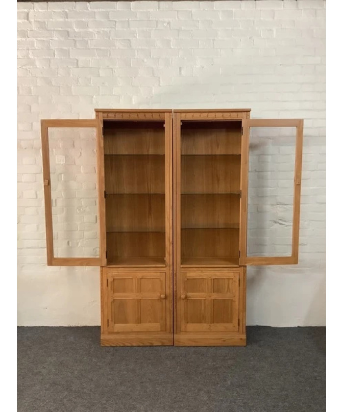 Pair Of Ercol Mural Glazed Cabinets In Light Finish.