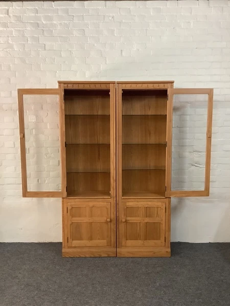 Pair Of Ercol Mural Glazed Cabinets In Light Finish.