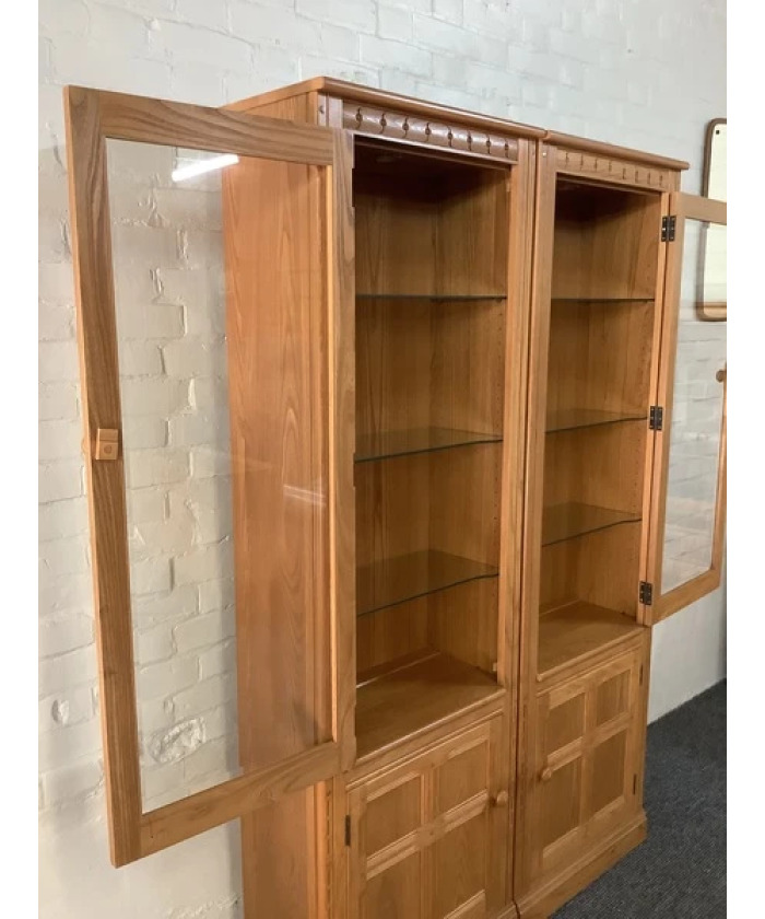 Pair Of Ercol Mural Glazed Cabinets In Light Finish.