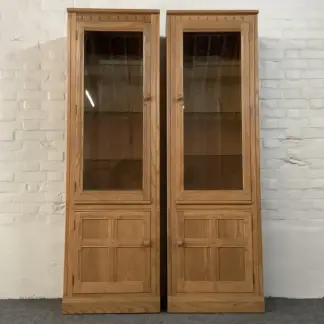 Pair Of Ercol Mural Glazed Cabinets In Light Finish.