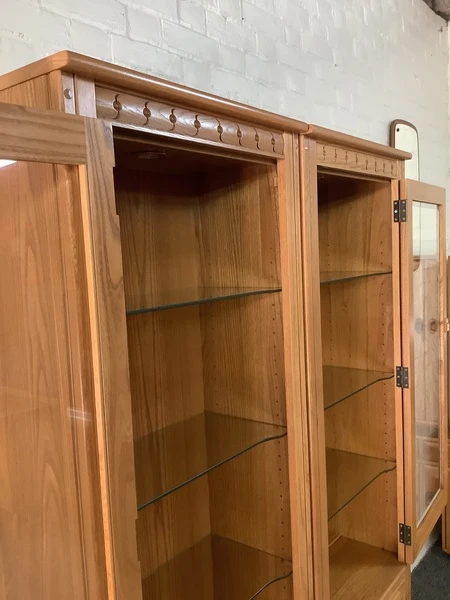 Pair Of Ercol Mural Glazed Cabinets In Light Finish.