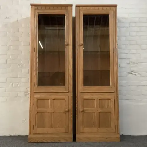 Pair Of Ercol Mural Glazed Cabinets In Light Finish.