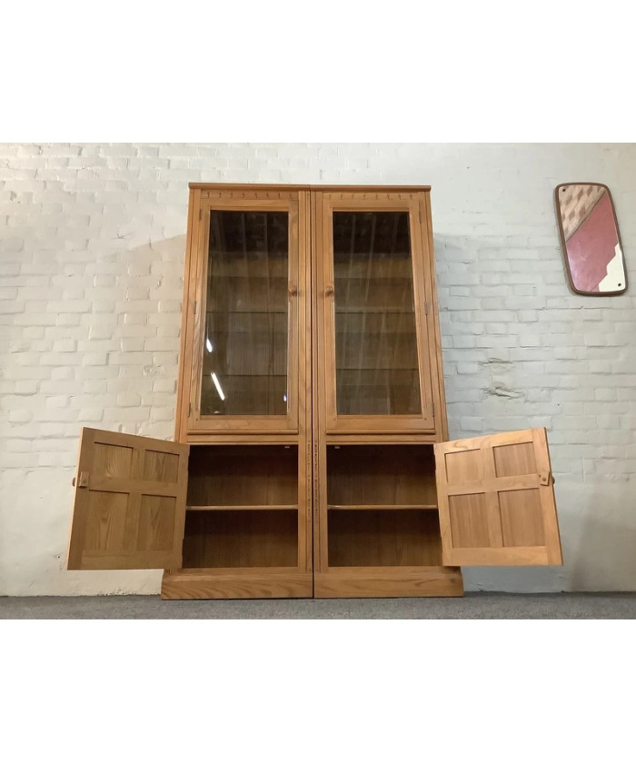 Pair Of Ercol Mural Glazed Cabinets In Light Finish.