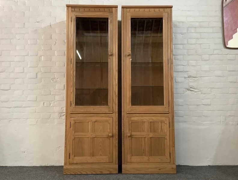 Pair Of Ercol Mural Glazed Cabinets In Light Finish.